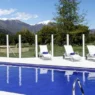 a pool with chairs and a fence