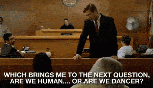 a man in a suit standing in front of a courtroom