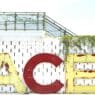 a large red and yellow sign on a white brick wall