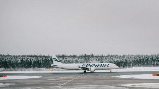an airplane on a runway with trees in the background