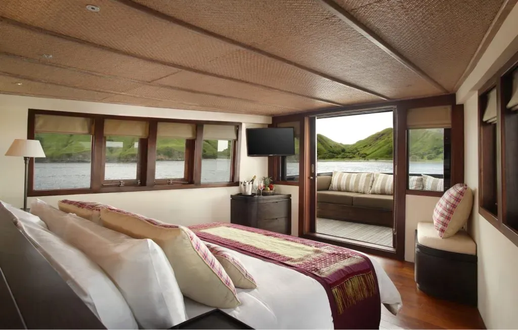 a bedroom with a bed and a television on the deck