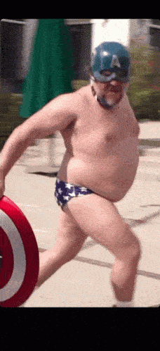a man in a bathing suit running on a beach