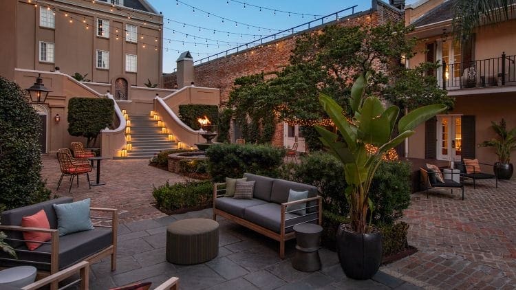 a patio with a couch and stairs and a staircase
