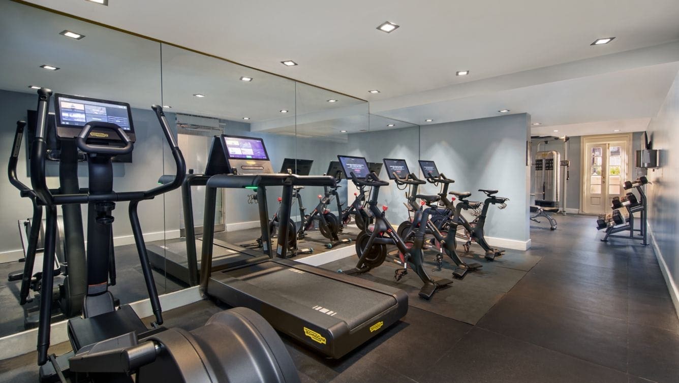 a room with exercise bikes and treadmills