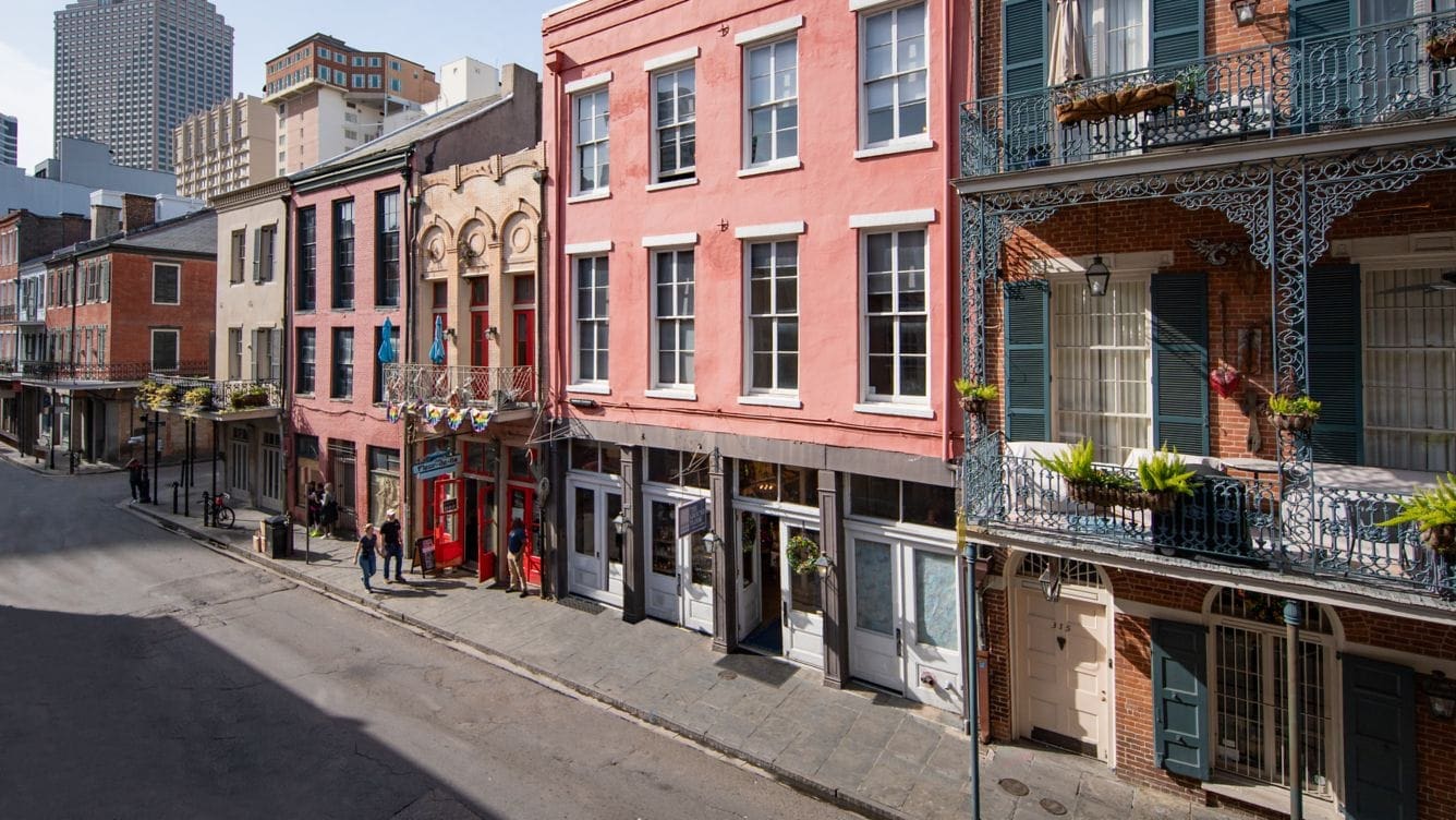 a street with buildings and people walking on it