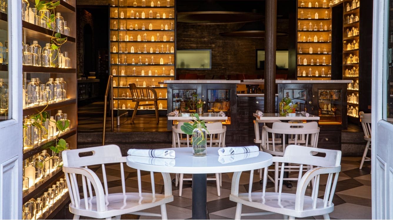 a table with chairs and a vase on it