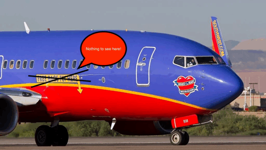 a blue and red airplane on a runway