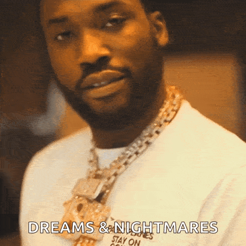 a man wearing a white shirt and a gold chain