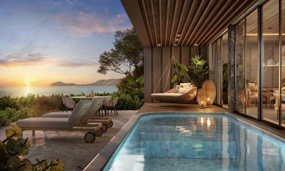 a swimming pool with a deck and chairs on the side