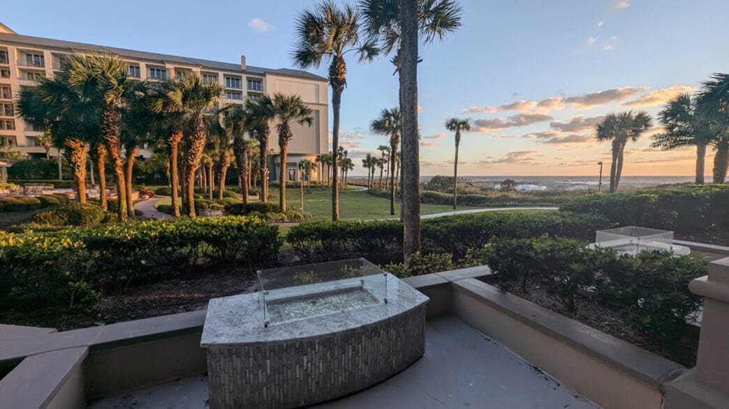 a stone fountain with a pool in front of a building