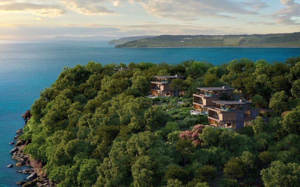 a group of houses surrounded by trees and water