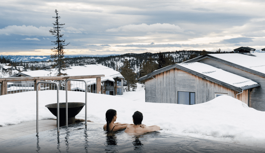 a couple in a pool in the snow