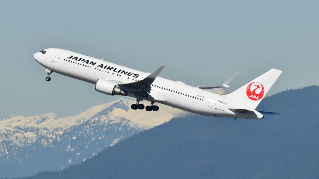 a white airplane flying in the sky