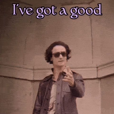 a man wearing sunglasses and holding a gun