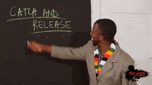 a man pointing at a chalkboard