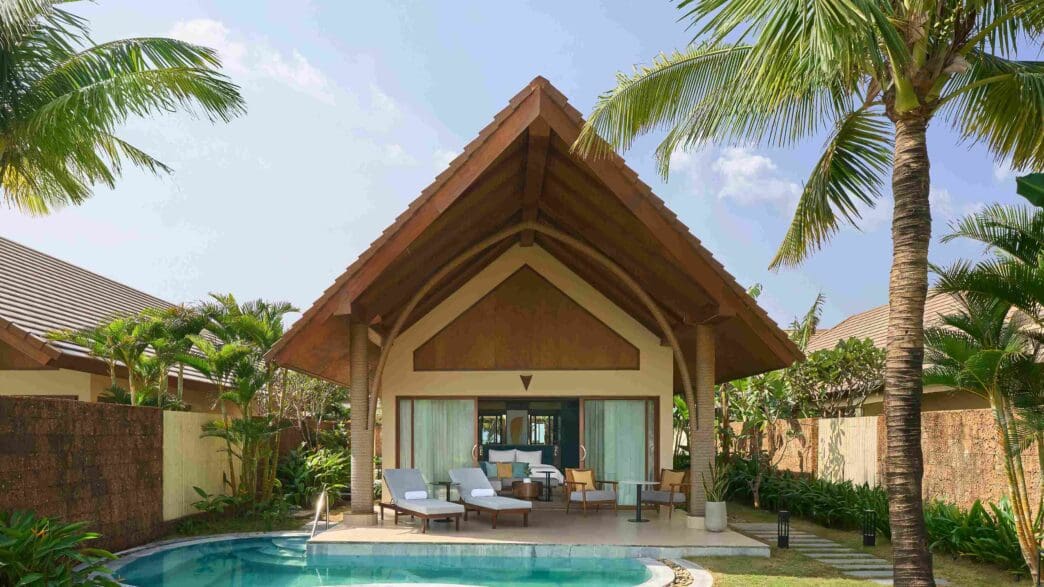 a house with a pool and chairs