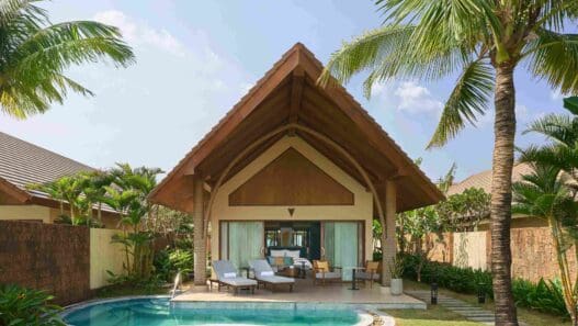 a house with a pool and chairs
