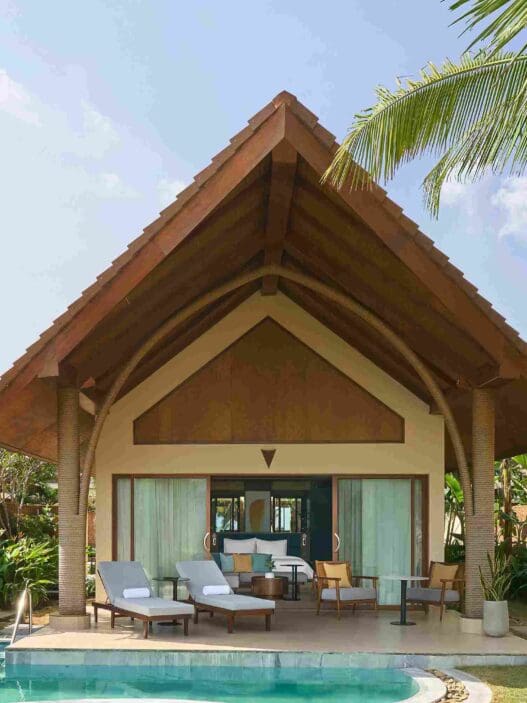 a house with a pool and chairs