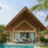 a house with a pool and chairs