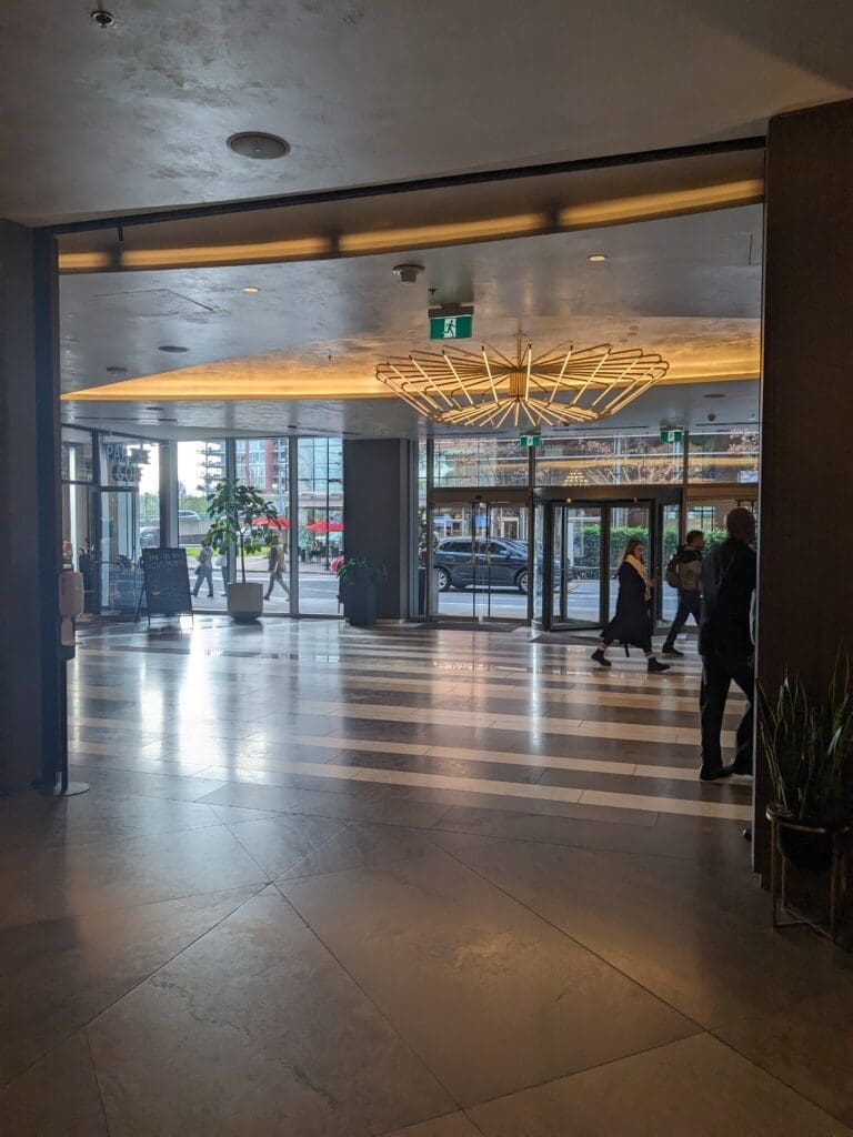 a building with glass doors and people walking