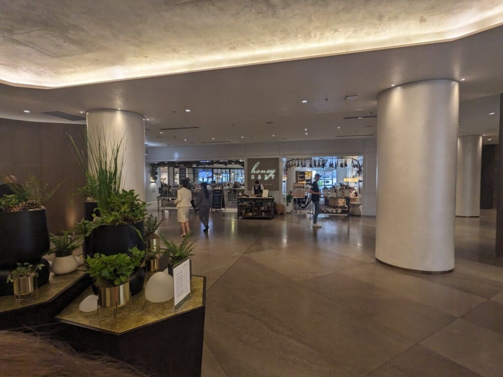 a large lobby with columns and people walking