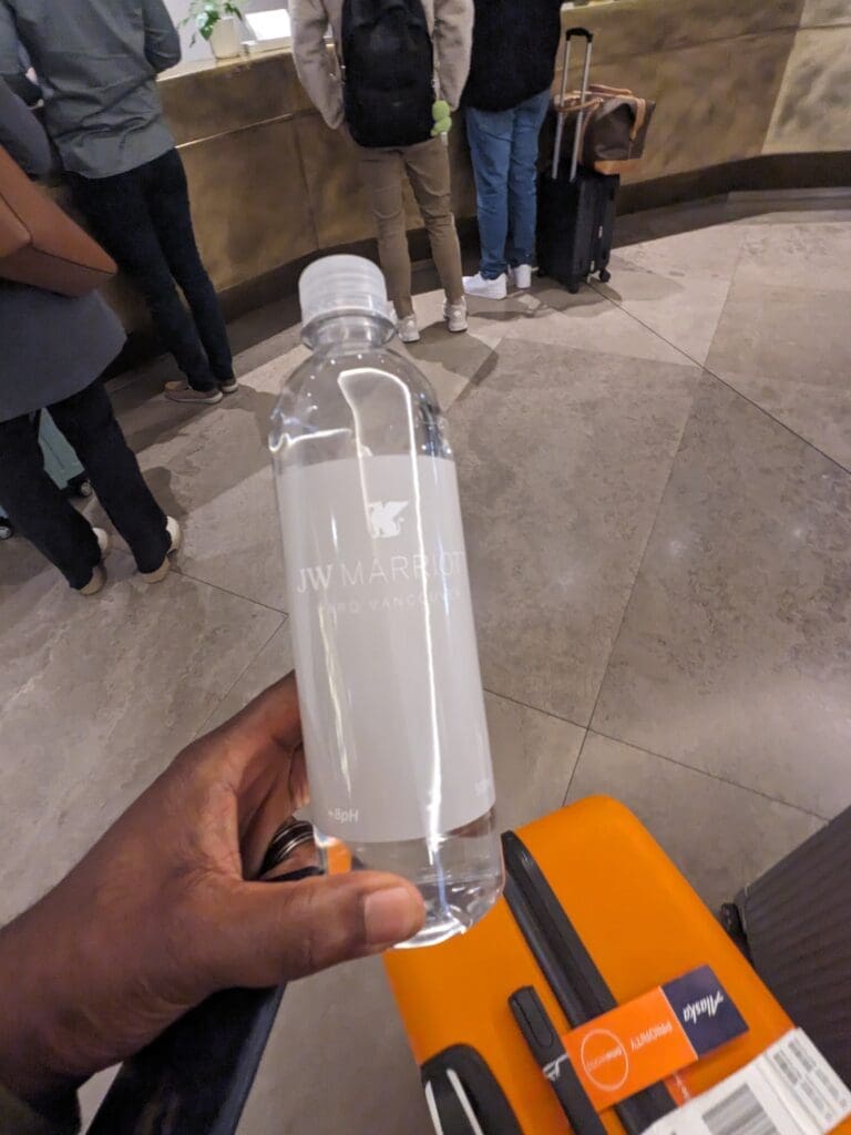 a hand holding a bottle of water