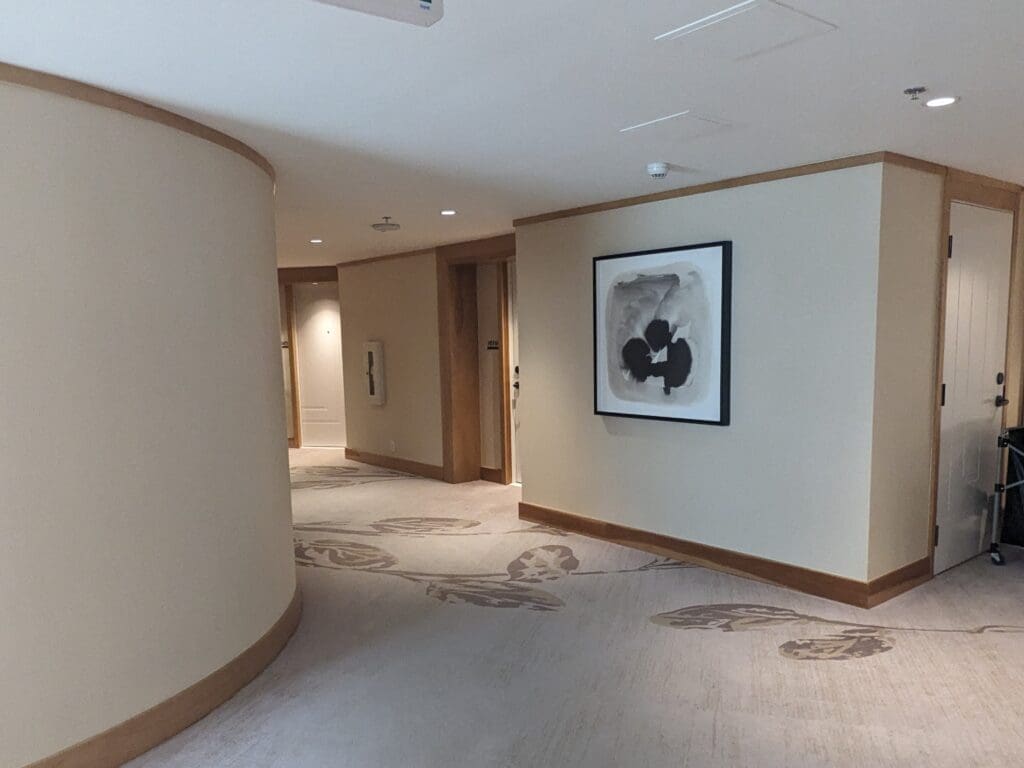 a hallway with a painting on the wall