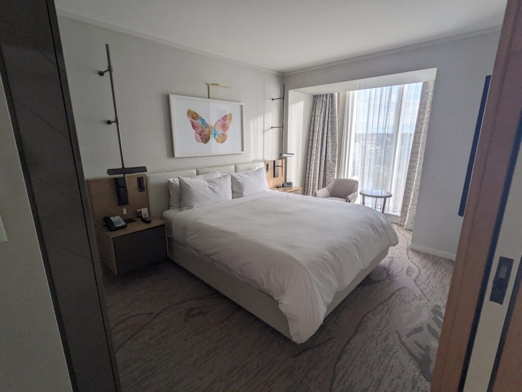 a bedroom with a bed and a chair