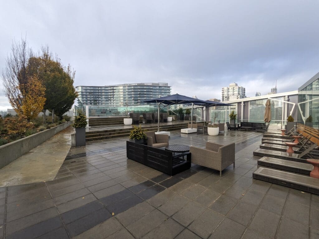 a patio with chairs and umbrellas