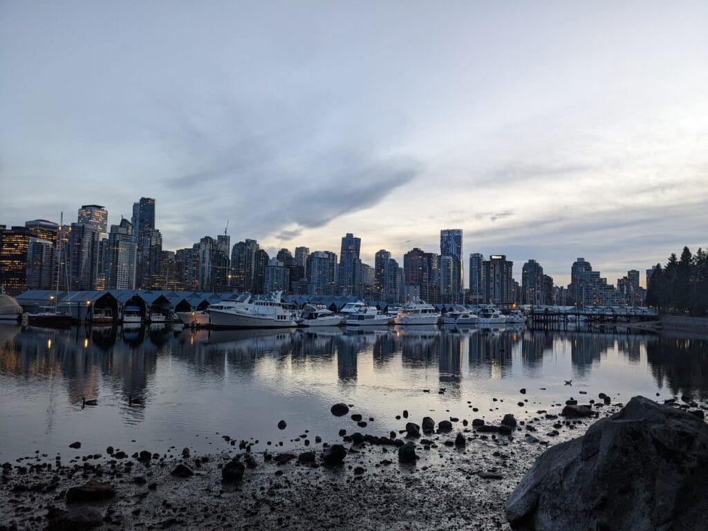 a city skyline with boats in the water