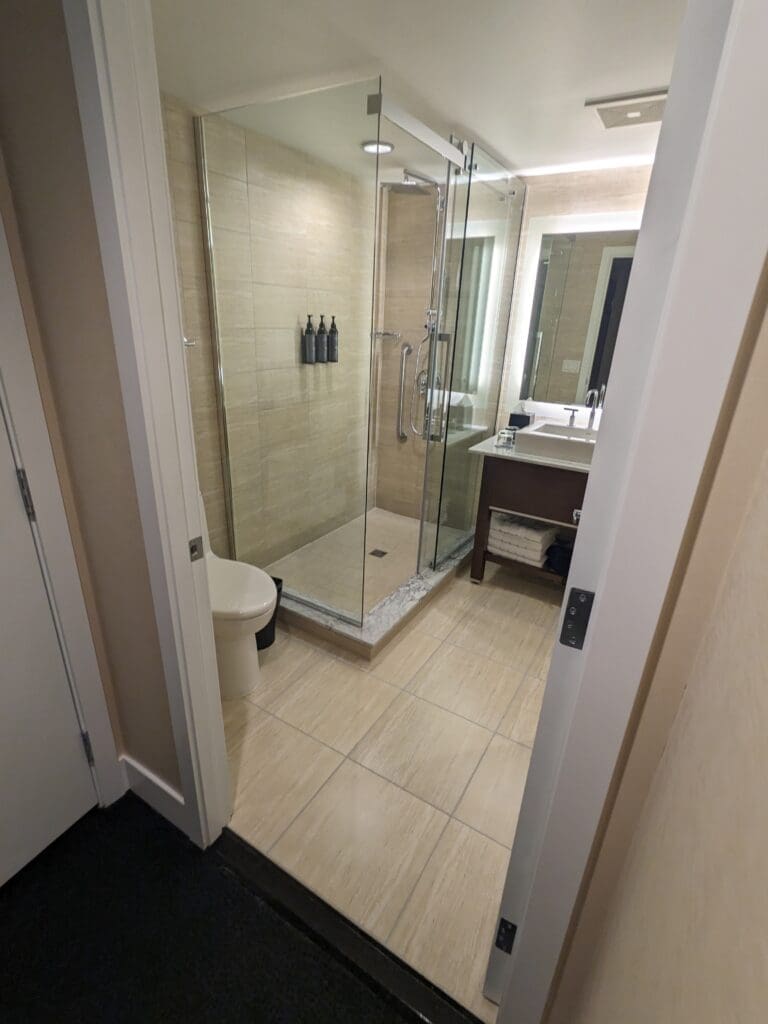 a bathroom with a glass shower and sink