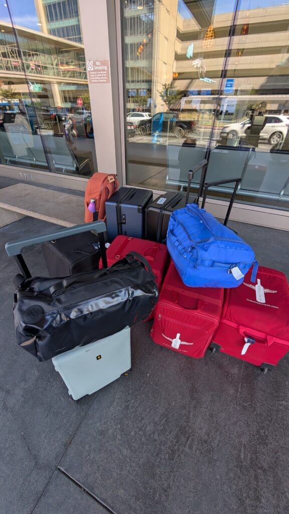 a group of luggage on a sidewalk