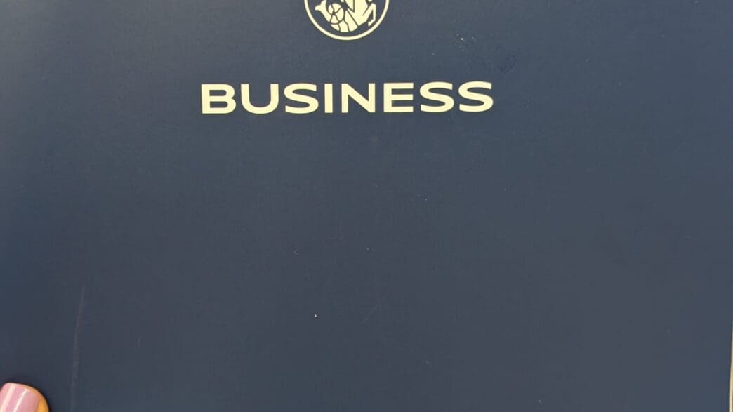 a person's finger pointing at a business logo