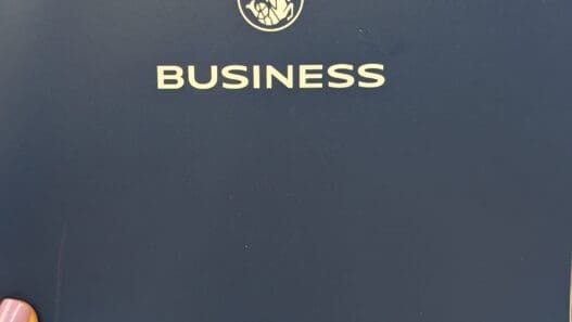 a person's finger pointing at a business logo