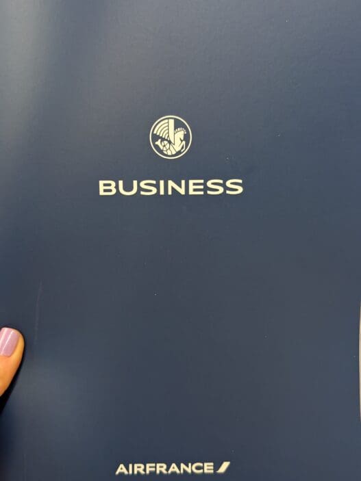 a person's finger pointing at a business logo