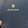 a person's finger pointing at a business logo