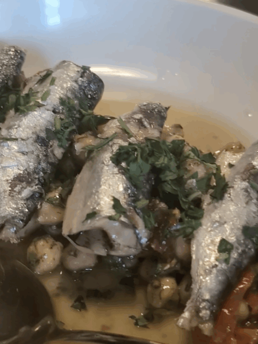 a bowl of fish with a spoon