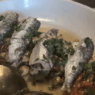 a bowl of fish with a spoon