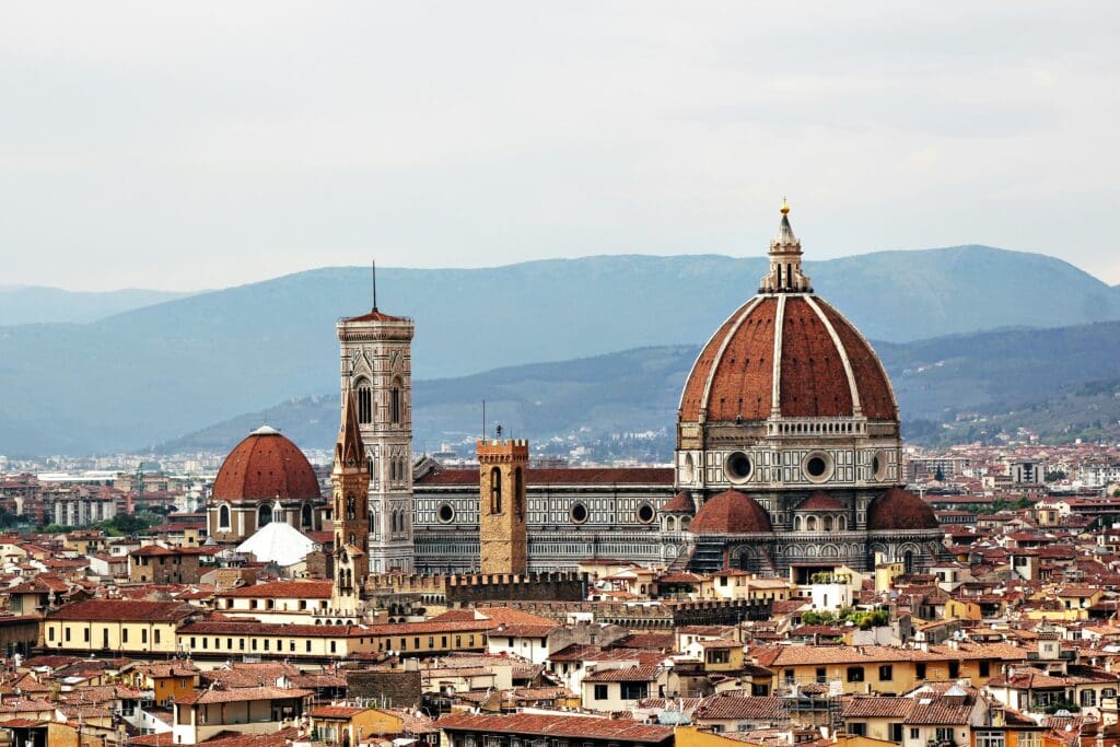 a large building with a dome and towers with Florence Cathedral in the background