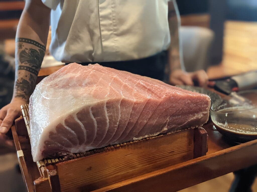 a person holding a piece of meat