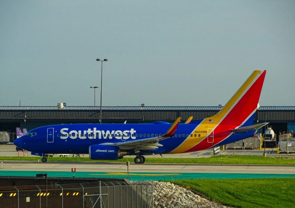 a blue airplane on a runway