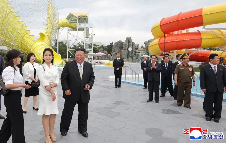 a group of people standing in front of a water park