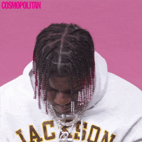 a man with braids wearing a white hoodie