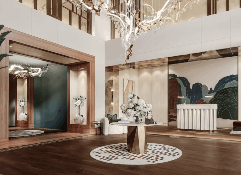 a lobby with a round table and a chandelier