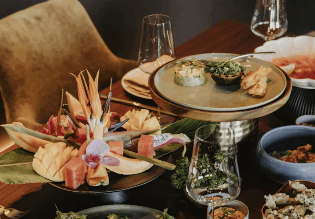 a table with plates of food and glasses