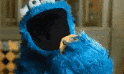 a blue puppet with mouth open