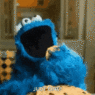a blue puppet with mouth open