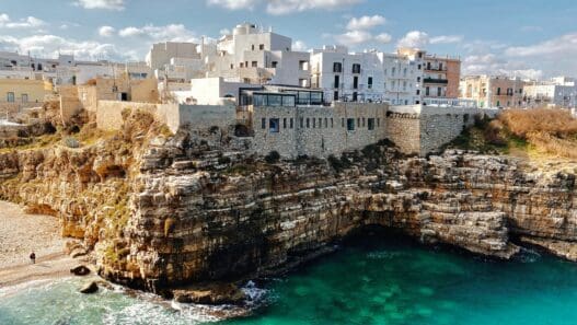 a building on a cliff above water