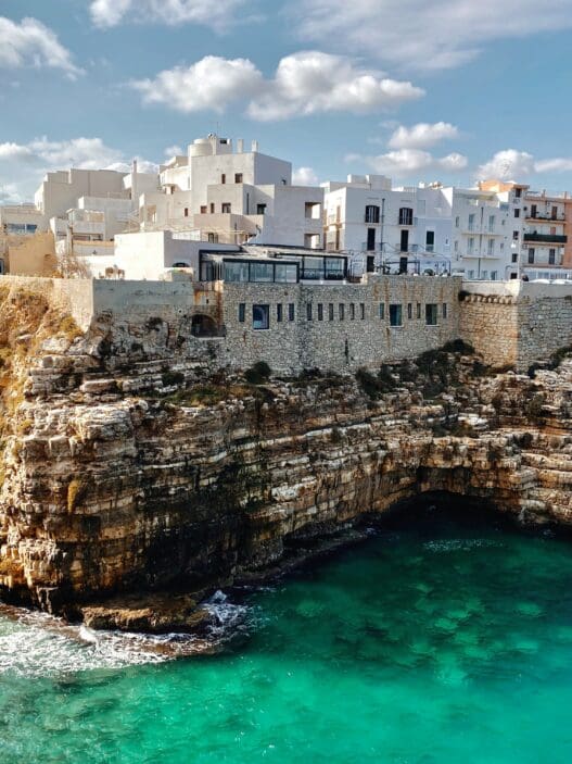 a building on a cliff above water