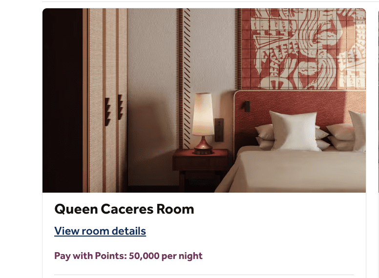 a bed with a lamp on a table
